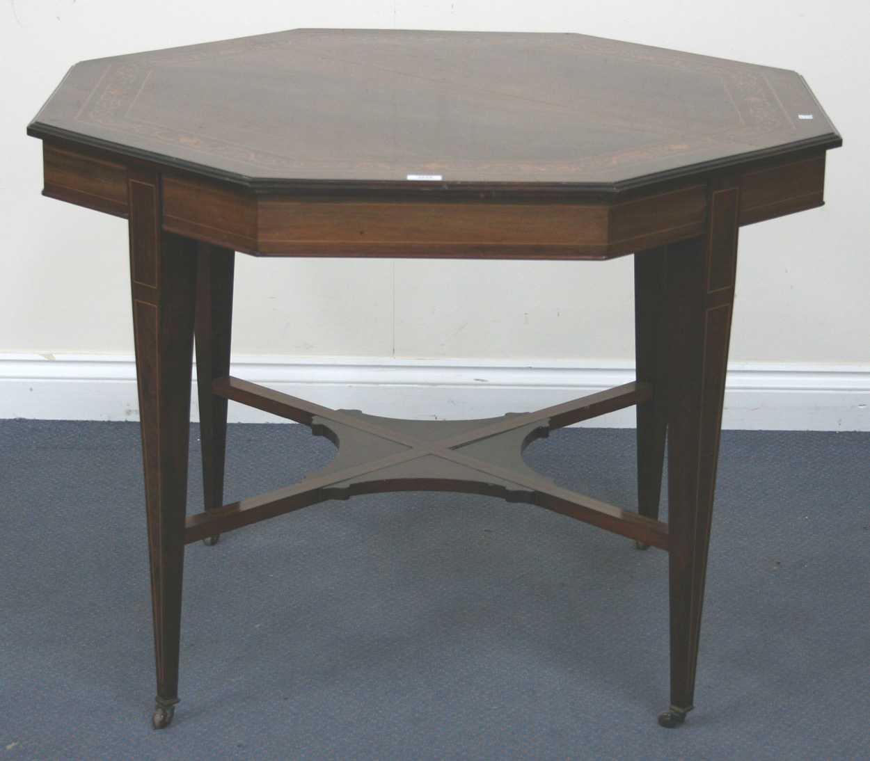 An Edwardian mahogany octagonal centre table, the moulded top with an ...