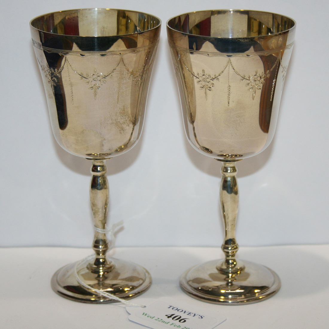 A set of six silver goblets, each bowl engraved with festoons, on a ...