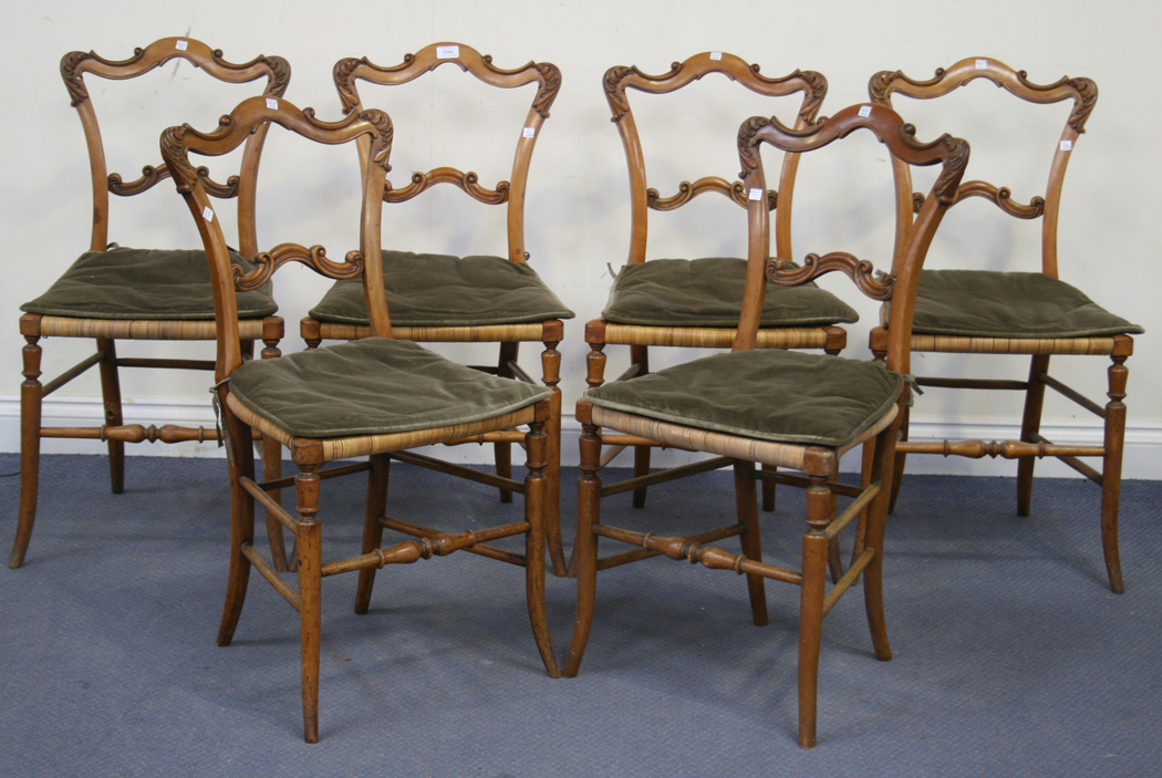 A Set Of Six Mid Victorian Satin Walnut Dining Chairs With Carved Foliate Backs And Cane Seats On S