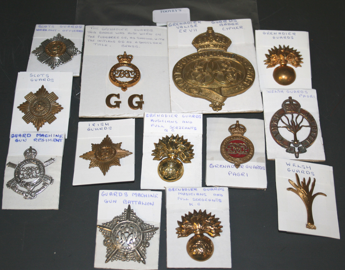 A collection of thirteen guards badges, including Guards Machine Gun ...