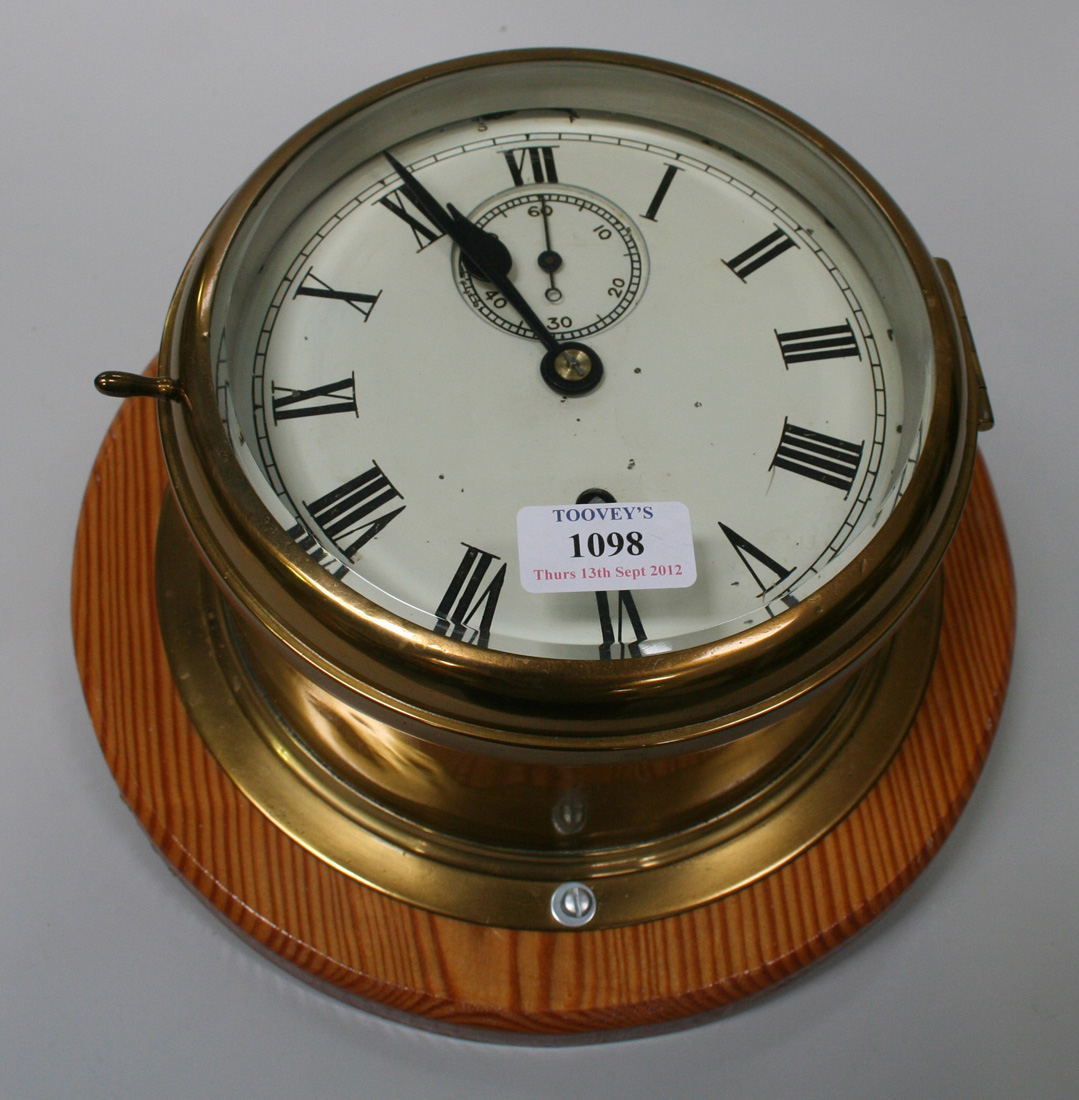 a-lacquered-brass-ships-clock-with-eight-day-movement-the-circular-white-dial-with-roman-numerals-a