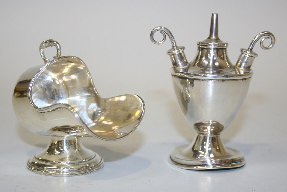 A late Victorian silver table lighter of urn form on a circular foot ...