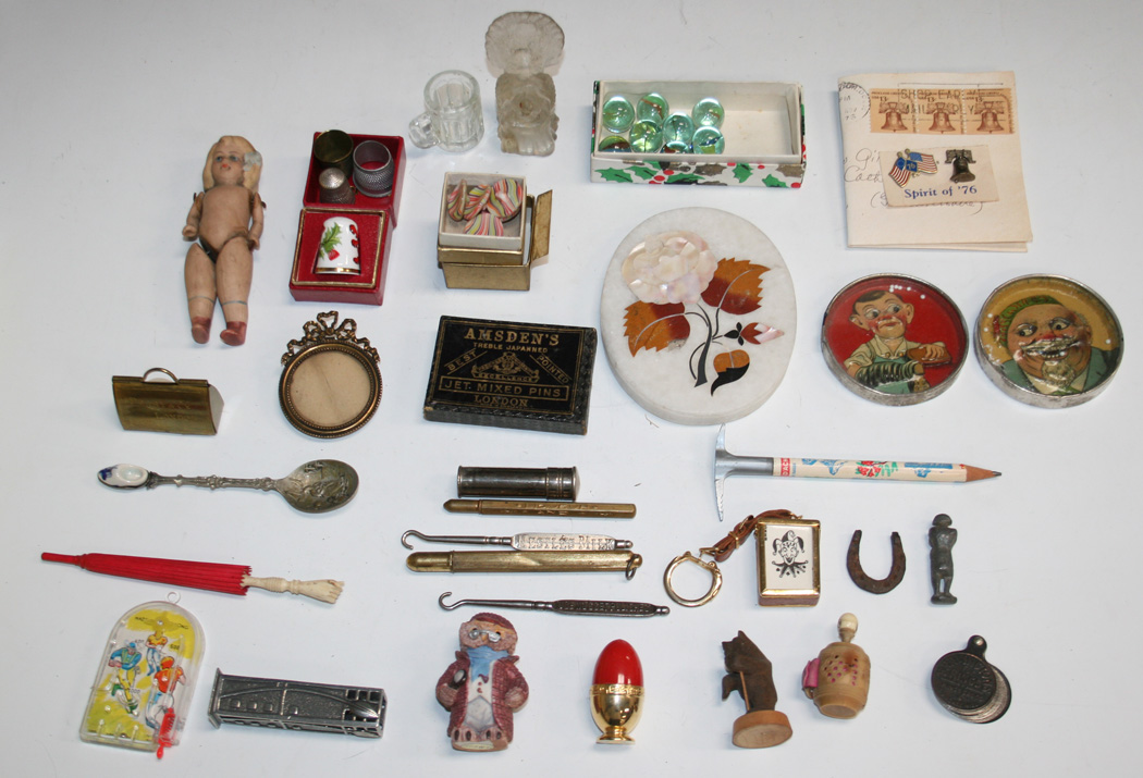 A group of collectors' items, including serving accoutrements, button ...