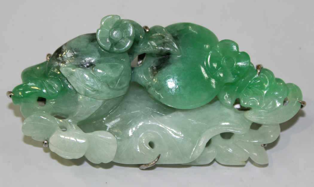 A Chinese jade brooch, 20th Century, carved and pierced in the form of ...