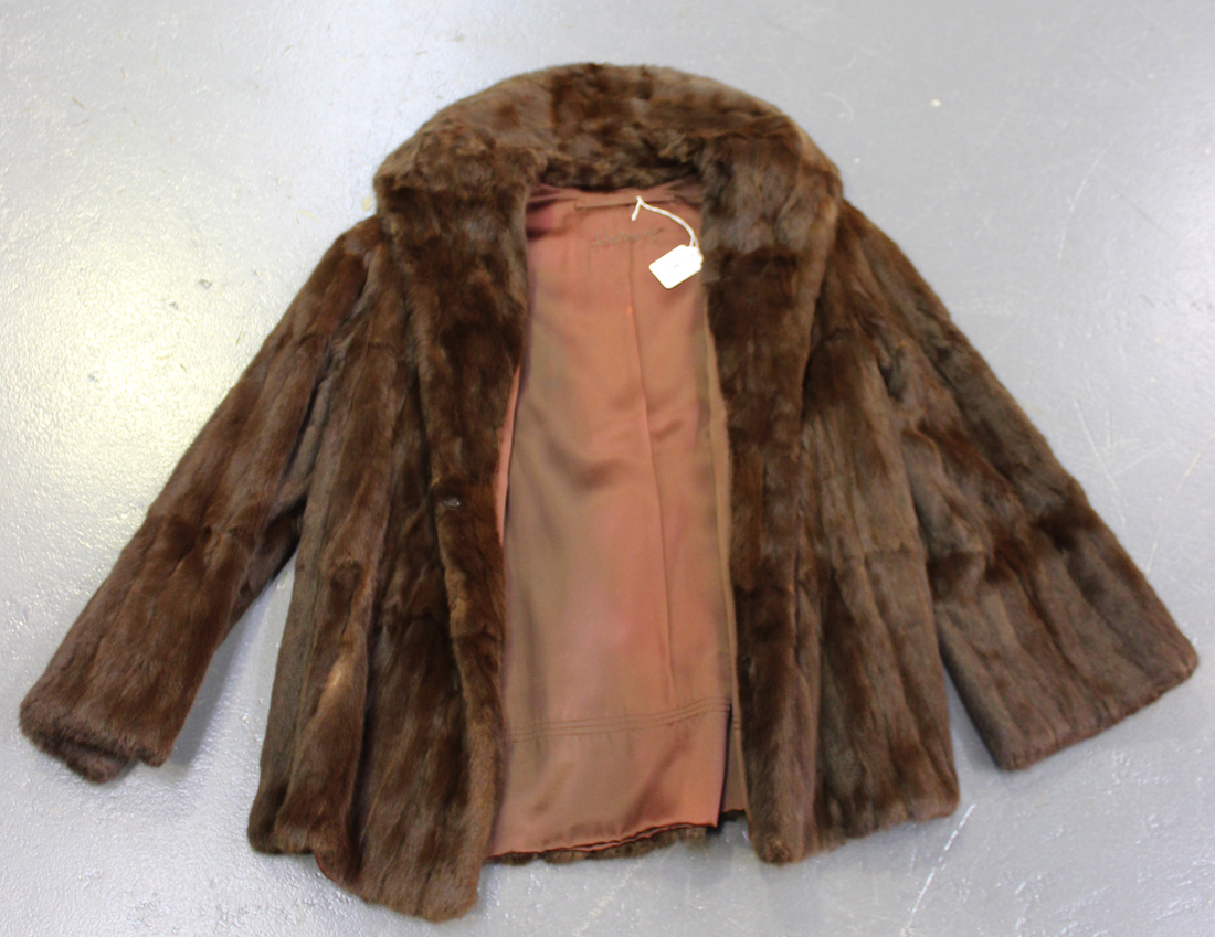 A mid-20th Century dark brown fur half-length coat, the lining ...