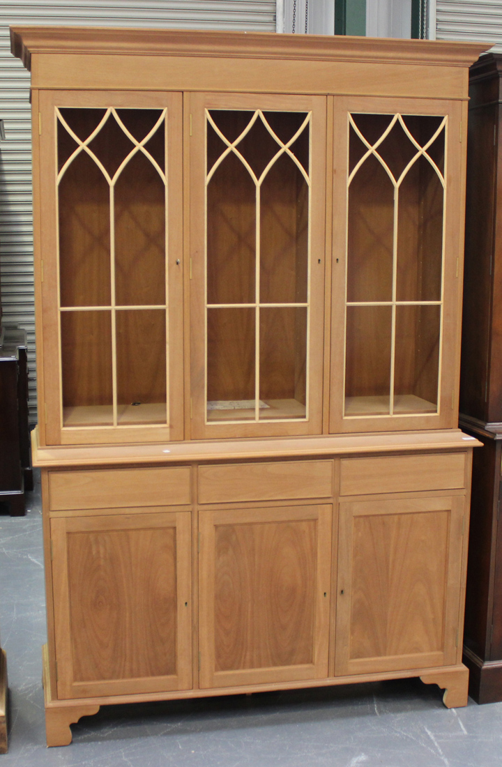 A modern reproduction mahogany bookcase fitted with three