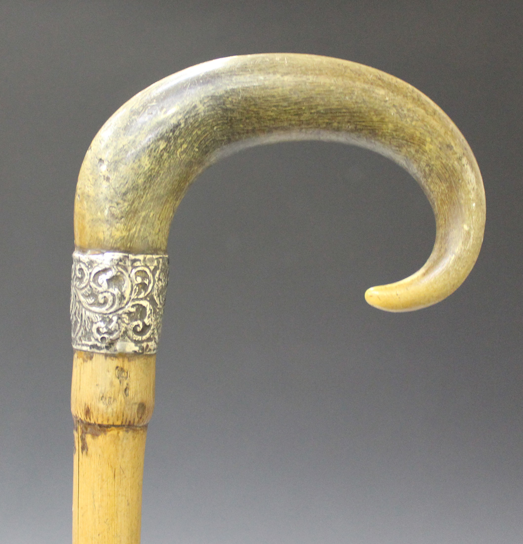 A 19th Century rhino horn handled knife sharpening steel, the turned handle  with brass mounts and su