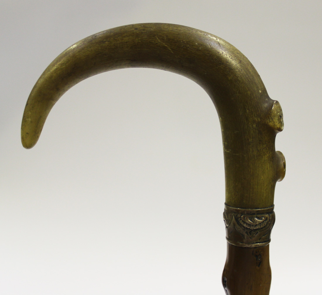 A 19th Century rhino horn handled knife sharpening steel, the turned handle  with brass mounts and su