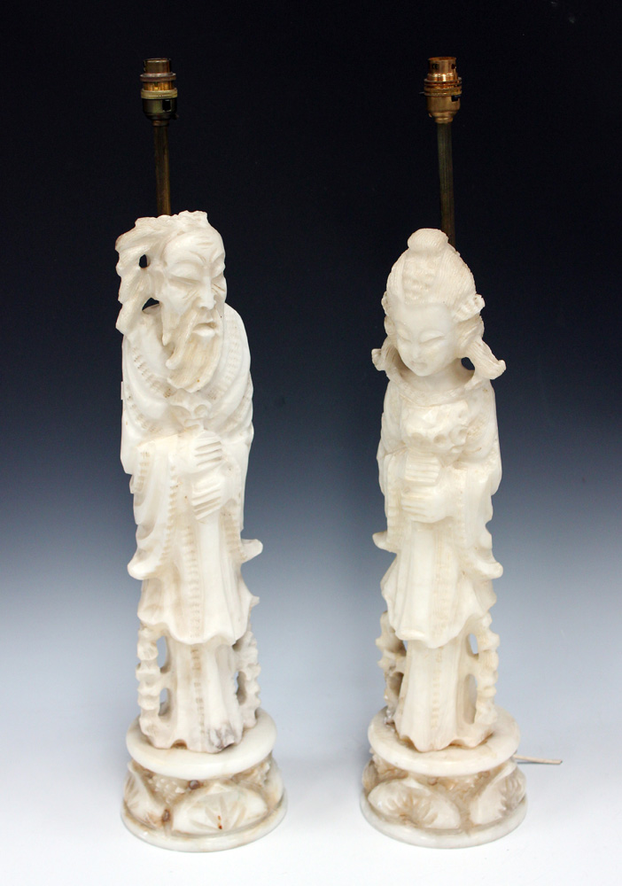 A pair of early 20th Century carved alabaster full-length figures of a