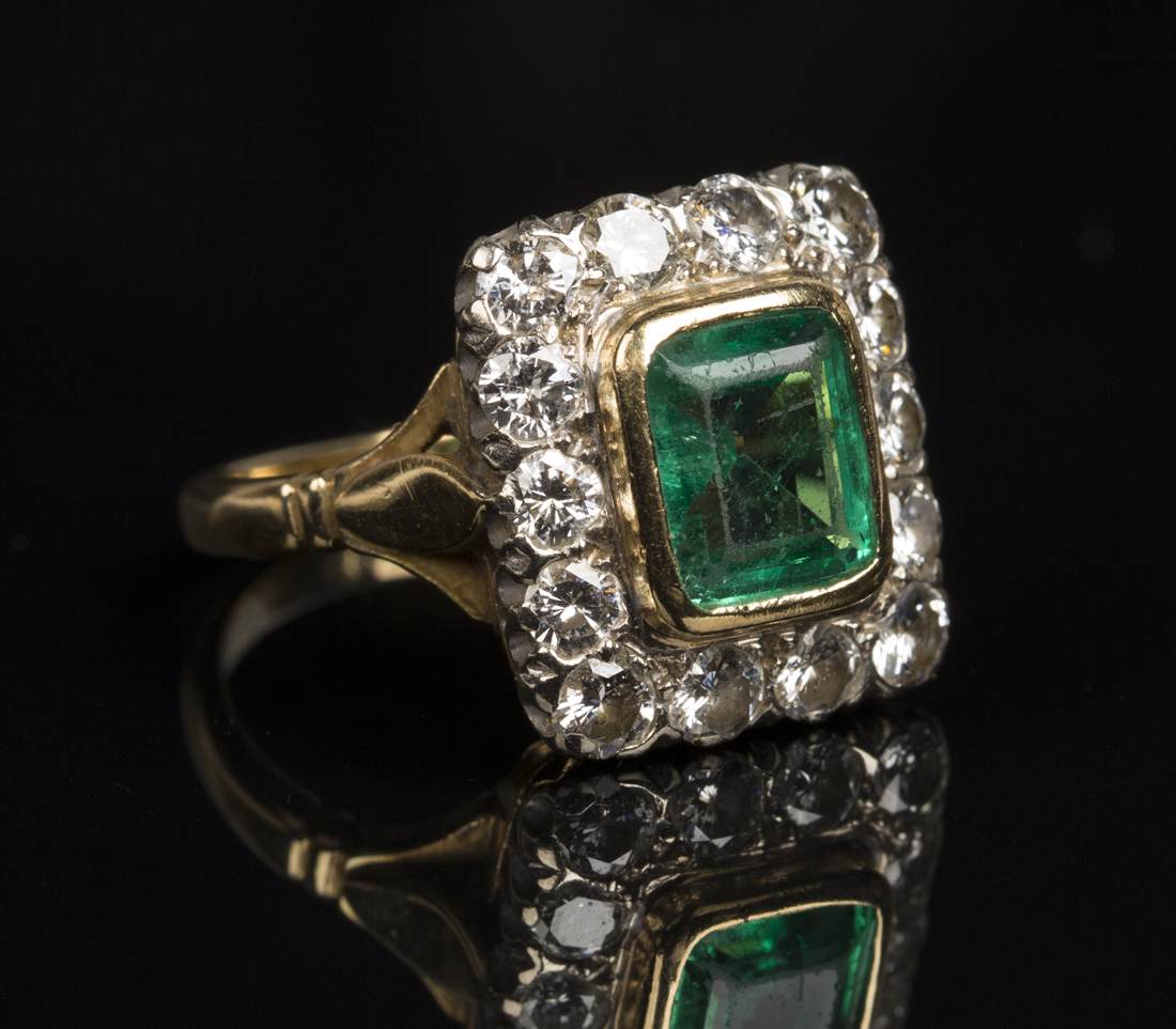 A gold, diamond and emerald rectangular cluster ring, the rectangular ...