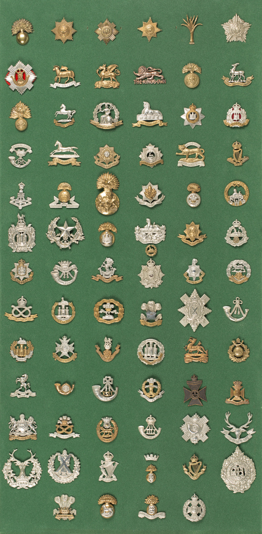 A collection of seventy-seven British Infantry cap badges, including ...