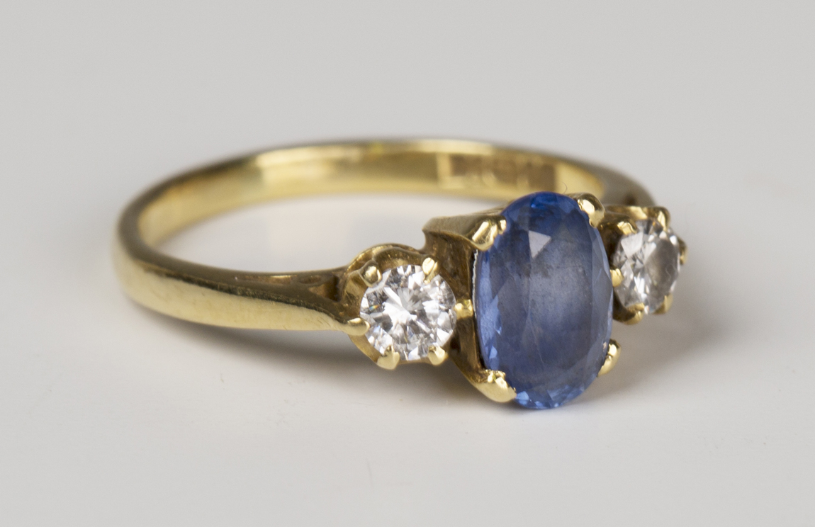 An 18ct gold, sapphire and diamond three stone ring, claw set with the ...