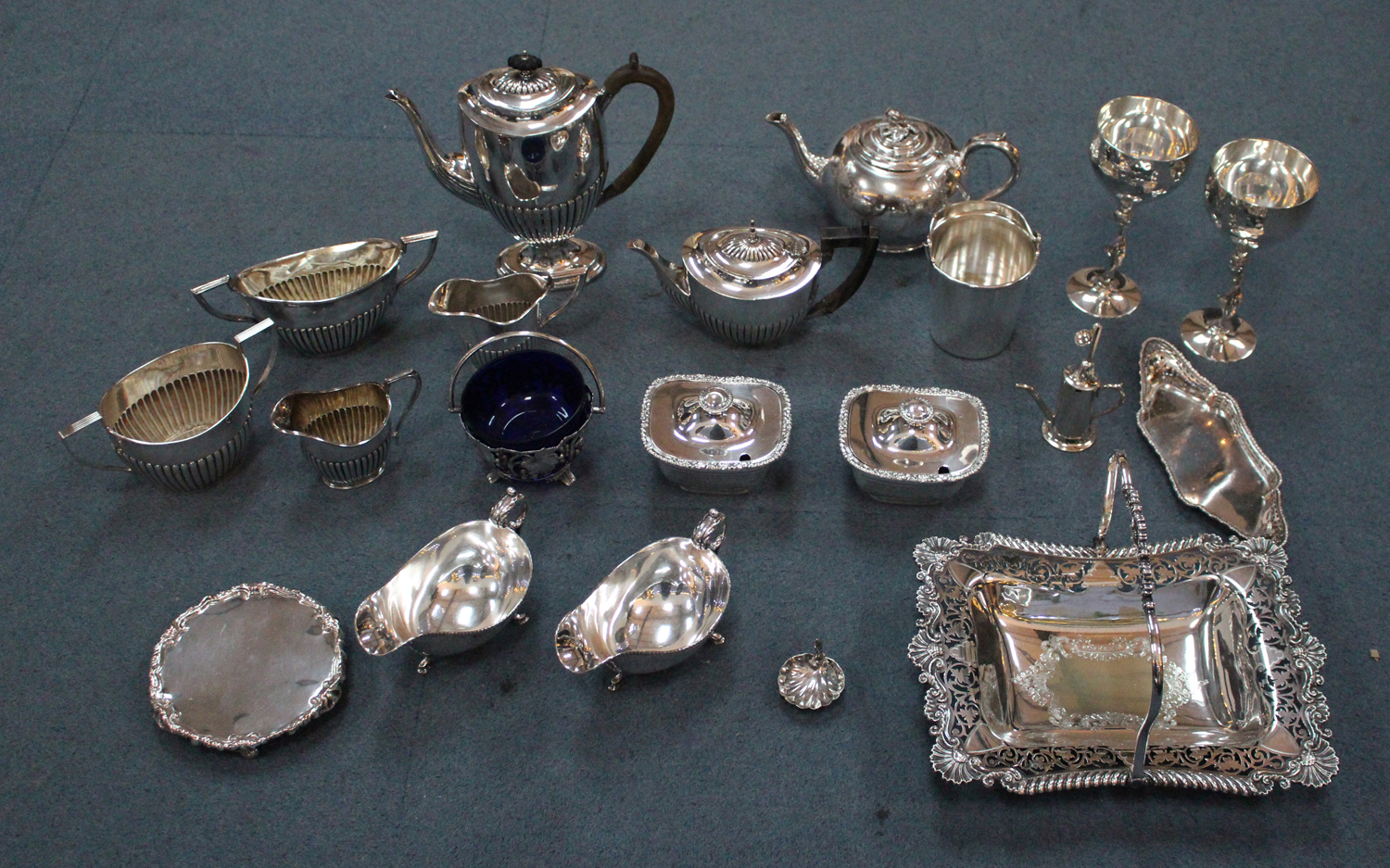 A collection of plated items, including a pair of sauce boats with ...