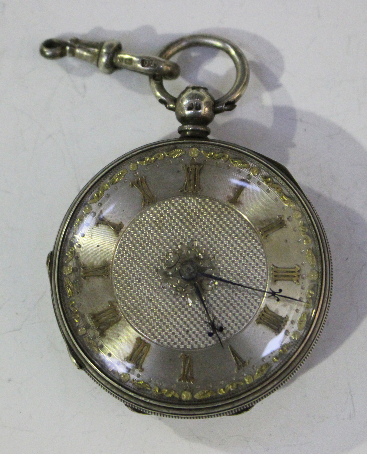 A silver cased keywind open-faced fob watch, the back plate detailed ...