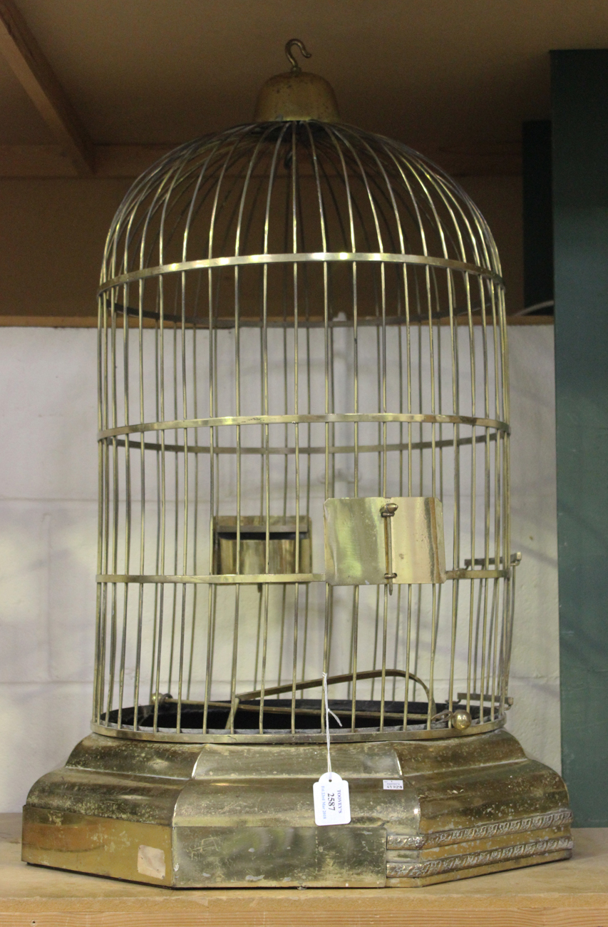 A 20th century Victorian style brass bird cage of domed form, fitted with  two feeders, a perch and a