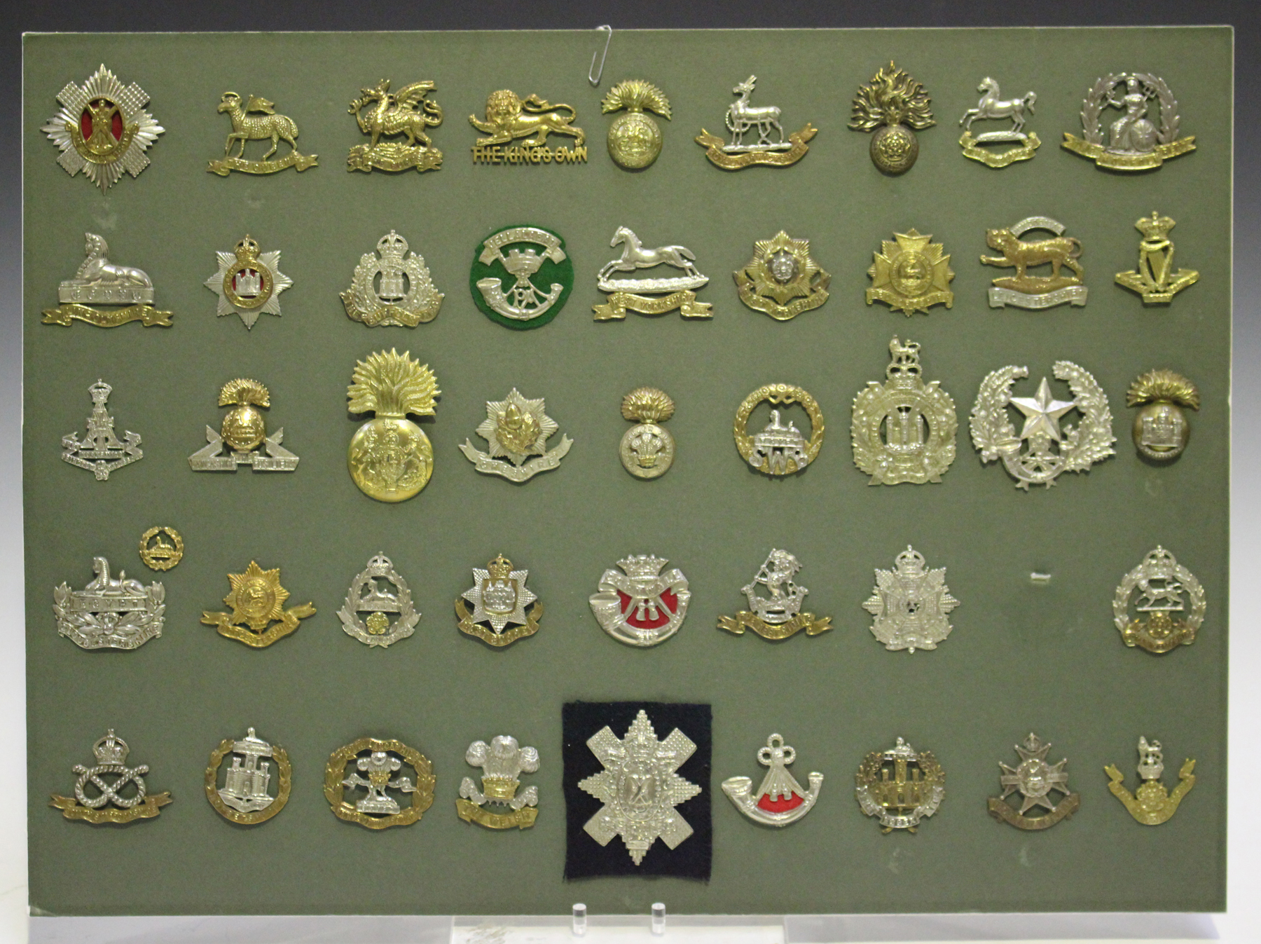 A collection of British cap badges, including Royal Highlanders, Prince ...