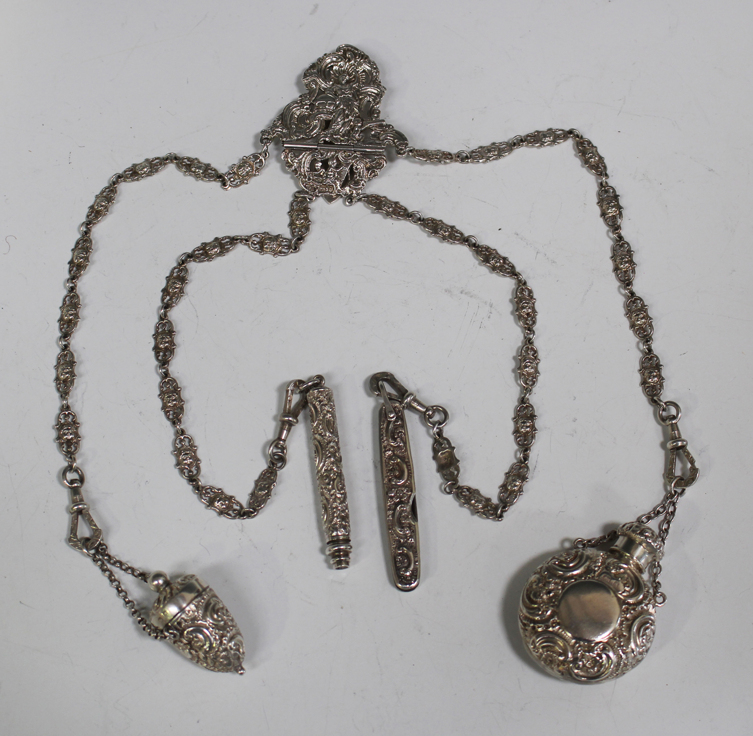 A late Victorian silver châtelaine, the clip pierced and cast with a ...