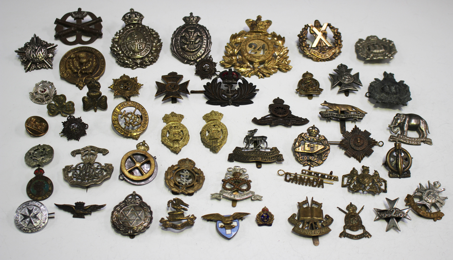 A large collection of military cap and other badges, including South ...