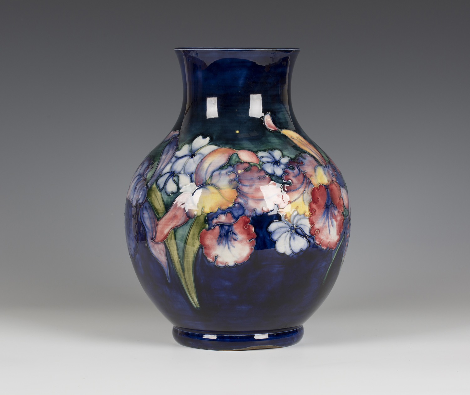 A large Moorcroft pottery Orchid pattern vase, circa 1940, with shaded ...