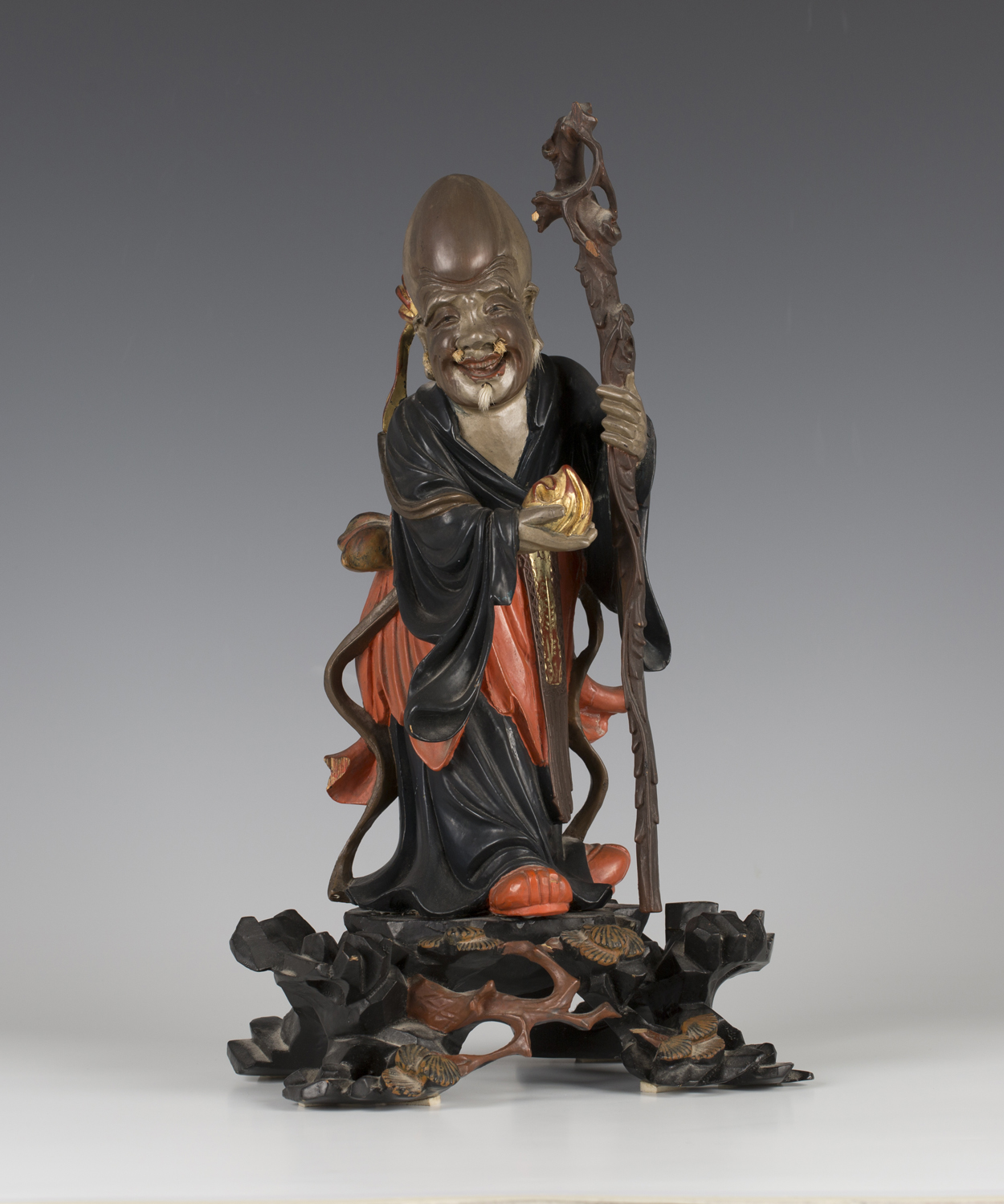 A Chinese lacquered carved wood figure of Shoulao, probably Fuzhou ...