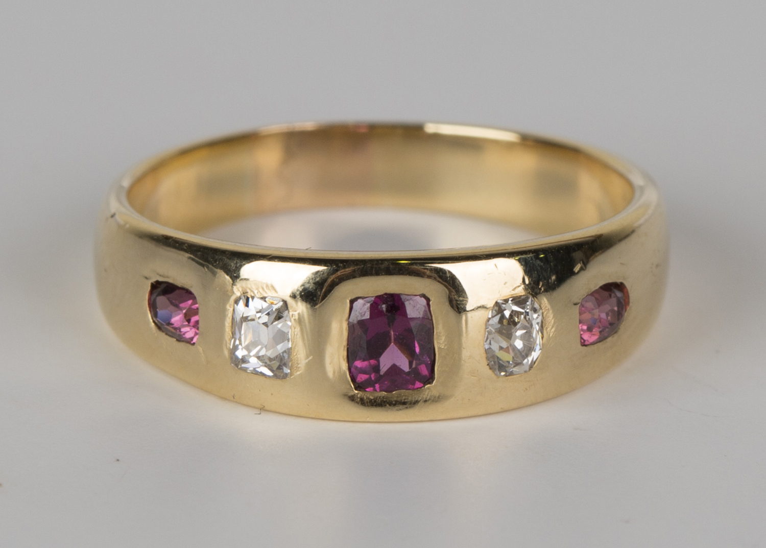 A gold, almandine garnet and diamond ring, mounted with three almandine ...