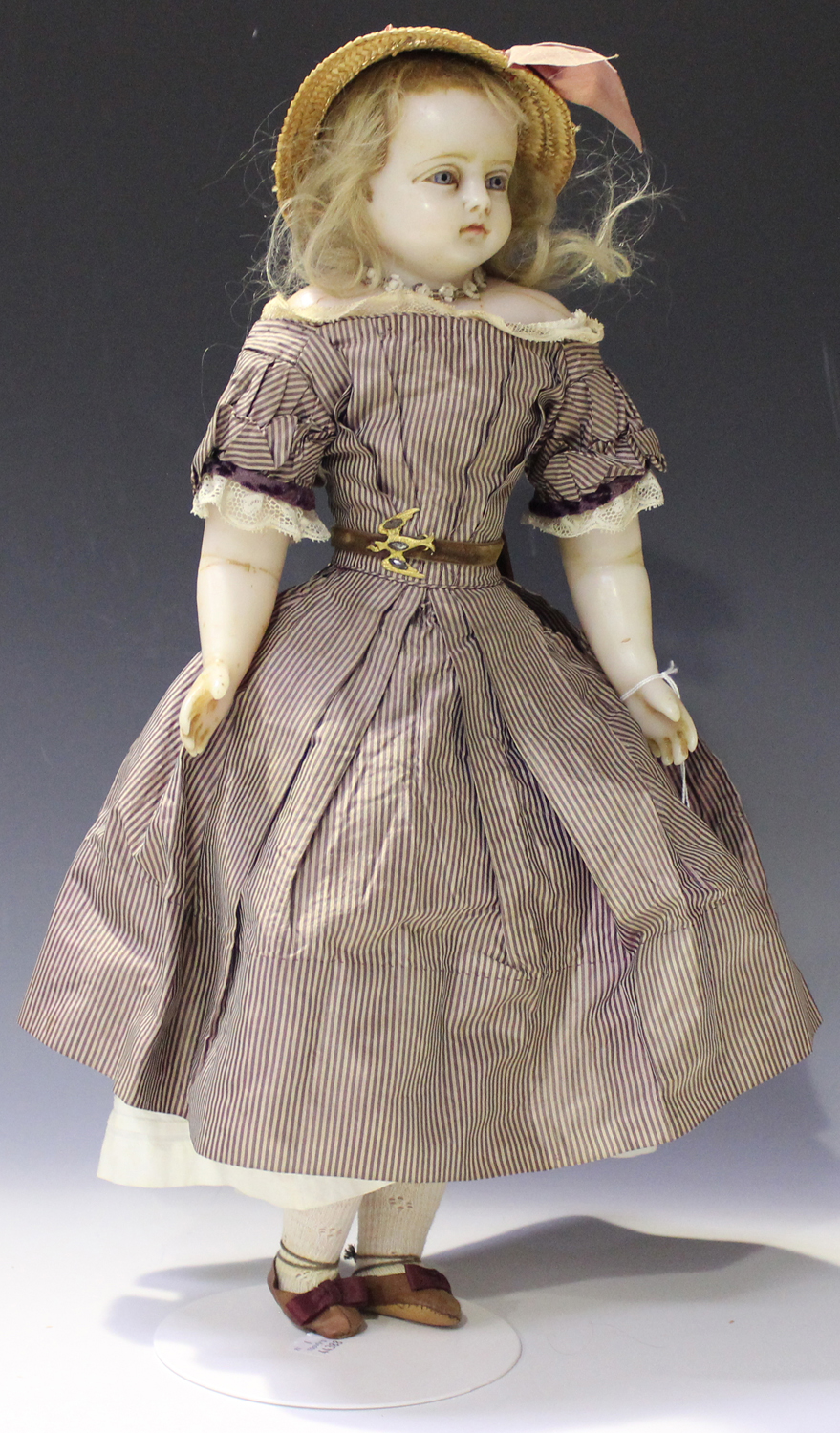 Victorian Woman holding a doll with a wasp waist look 1900 by Monterey  County Historical Society