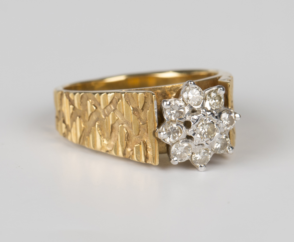 A gold and diamond nine stone cluster ring, mounted with circular cut ...