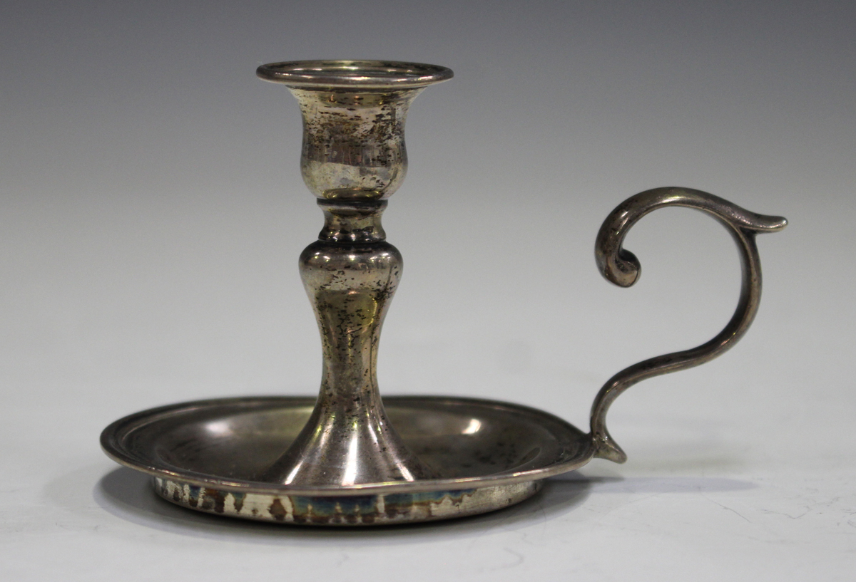 A Victorian silver taper chamberstick with urn shaped nozzle and