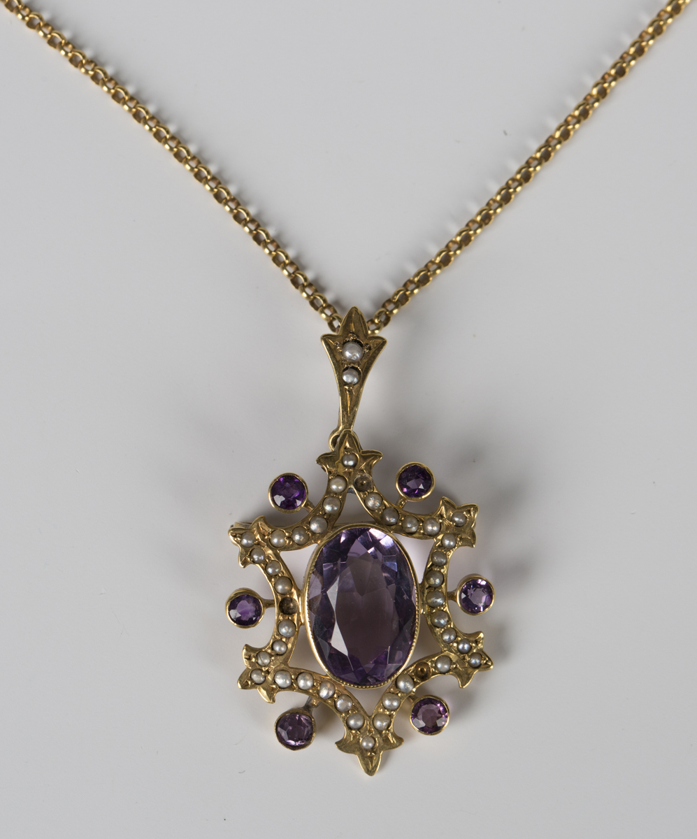 A gold, amethyst and seed pearl set pendant brooch, collet set with the ...