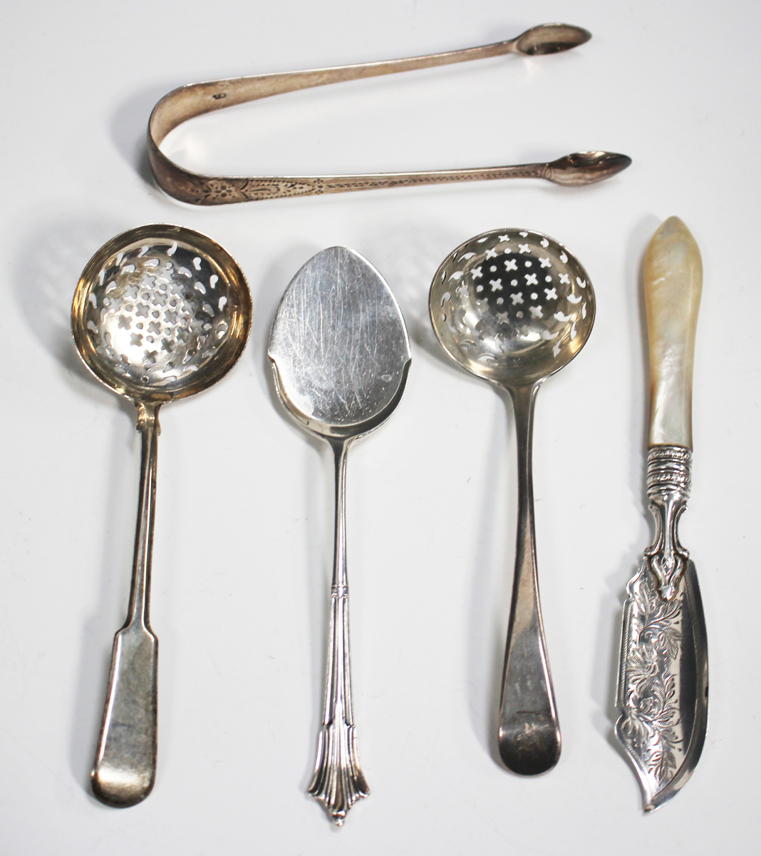 A Victorian silver butter knife with foliate engraved blade and mother ...