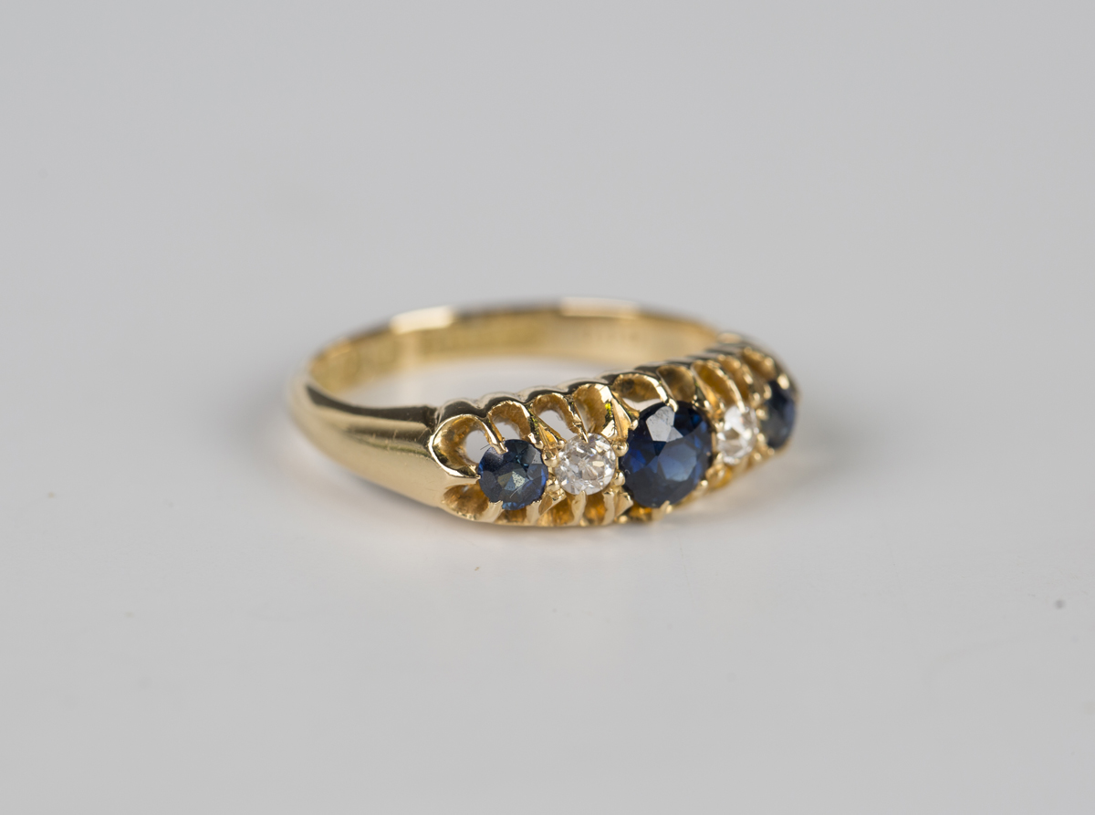 An 18ct gold, sapphire and diamond five stone ring, mounted with three ...