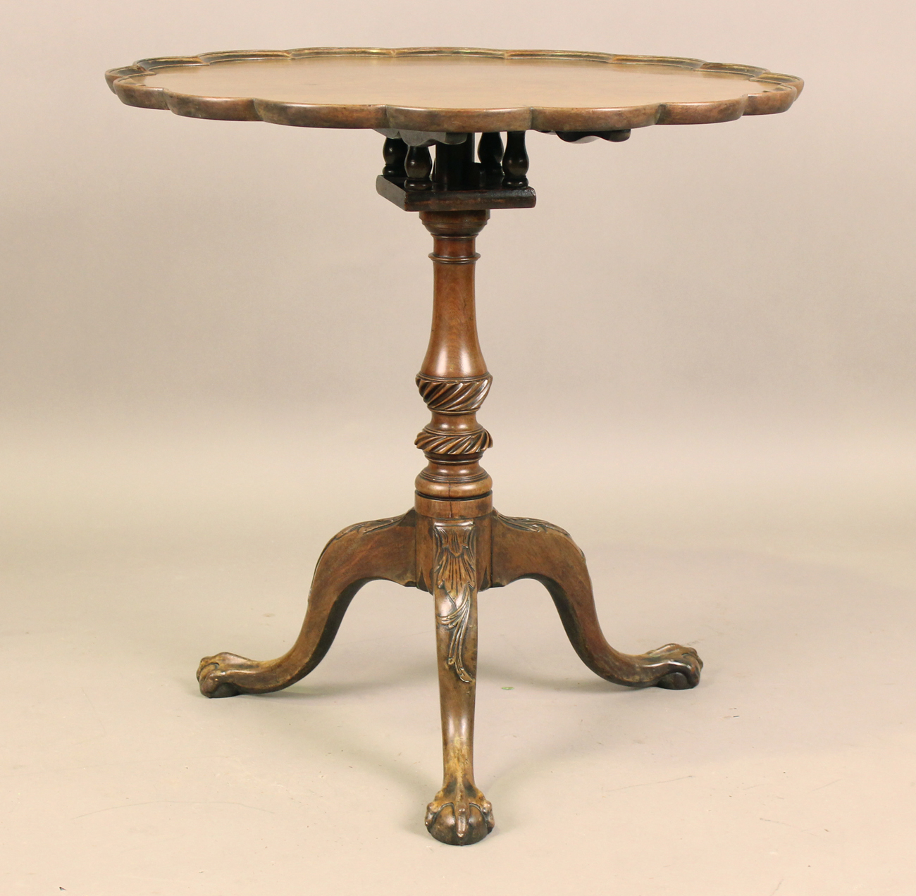 A George III mahogany tip-top wine table, the lobed circular top with a ...