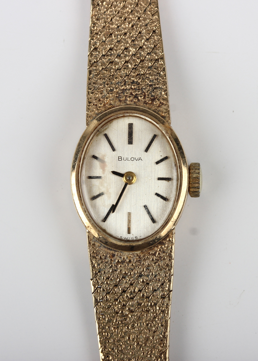 A Bulova 9ct gold lady's bracelet wristwatch, the signed oval silvered ...