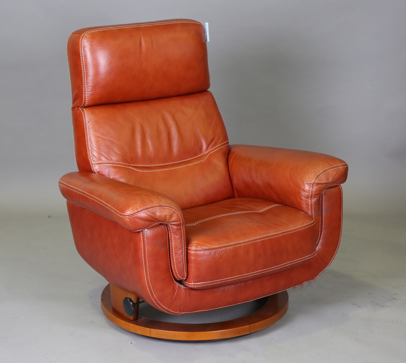 A Modern Brown Leather Armchair Of Retro Design Height 100cm Width 92cm Depth 75cm 