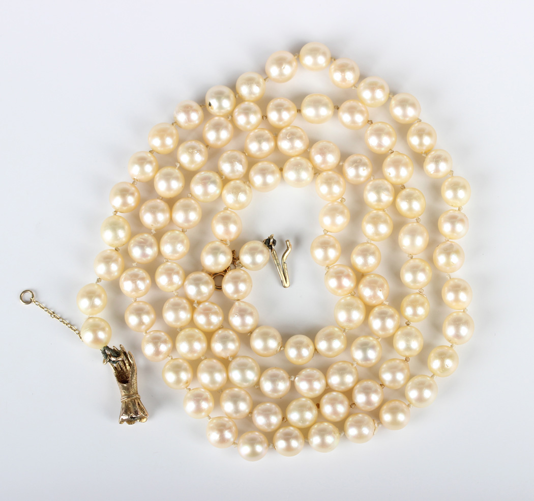 A single row necklace of uniform cultured pearls on a 9ct gold, diamond ...