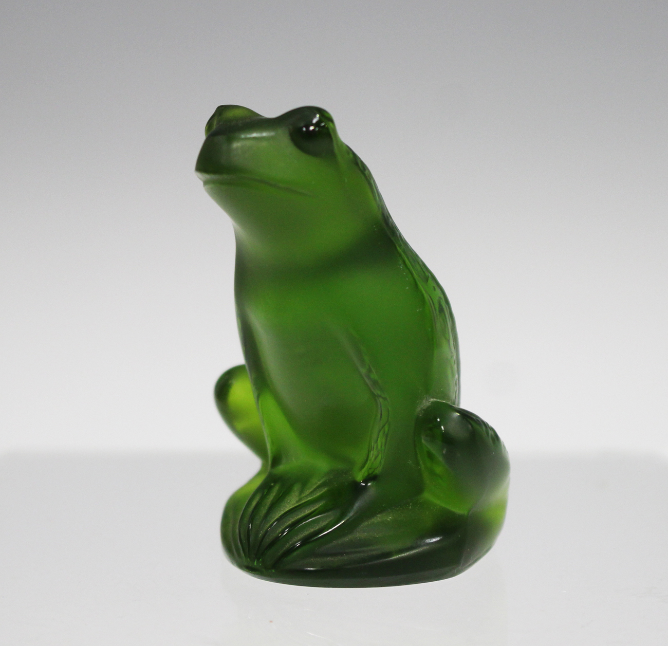 A Lalique glass model of a frog, modern, of dark green tint, engraved ...
