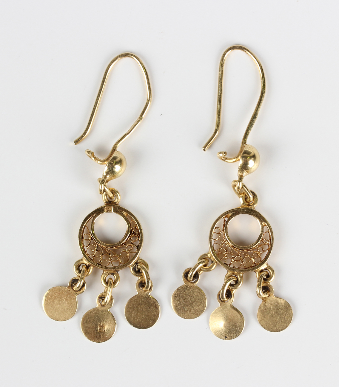 A pair of Egyptian gold earrings, each with three circular pendant ...