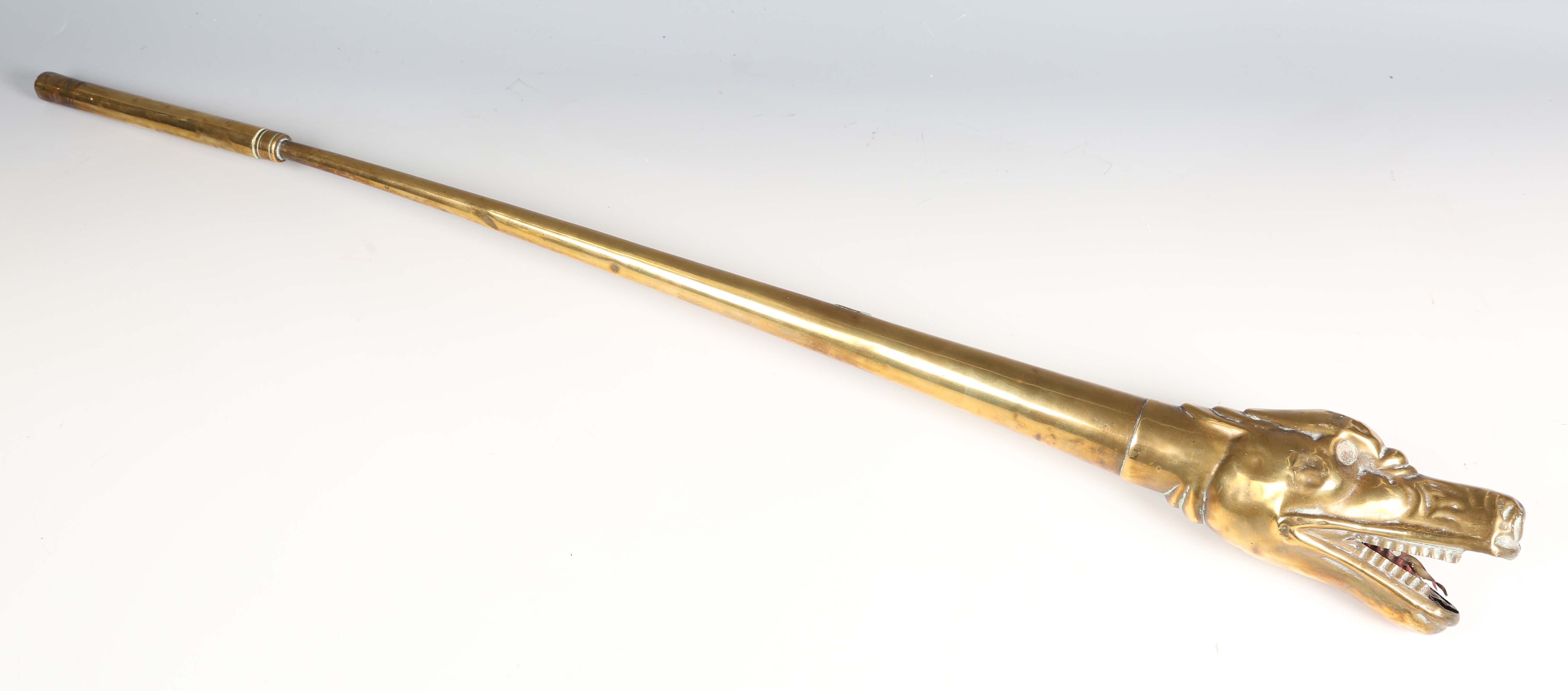 An early 20th century brass car horn, the mouth modelled as the head of