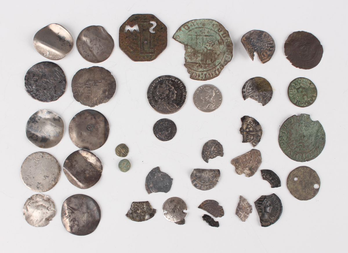 A collection of various metal detector-found coins, including Roman and ...